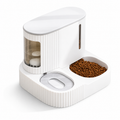 A white automatic pet feeder and water dispenser with a food bowl filled with kibble, shown on a clean white background.