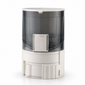A modern cylindrical dispenser or container with a translucent dark gray upper chamber and a cream-colored base, shown on a clean white background.