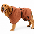 Dog wearing a brown towel with a paw print on a white background